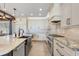 Kitchen with stainless appliances, white cabinets, stone countertops, and modern fixtures at 3640 Crump Rd, Winter Haven, FL 33881