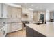 Kitchen with updated stainless appliances, stone countertops, white cabinets and modern fixtures at 3640 Crump Rd, Winter Haven, FL 33881