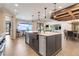 Spacious kitchen featuring a central island with stainless steel appliances and modern hanging lights at 3640 Crump Rd, Winter Haven, FL 33881