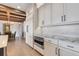 Kitchen featuring white cabinetry, stone backsplash, stainless oven and microwave, and modern hardware at 3640 Crump Rd, Winter Haven, FL 33881
