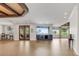 Spacious living area with beautiful wood floors, a custom bar, and scenic waterfront views at 3640 Crump Rd, Winter Haven, FL 33881