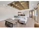 Bright living room with wood floors, stylish ceiling, and comfortable seating and a view into the kitchen at 3640 Crump Rd, Winter Haven, FL 33881
