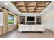 Comfortable living room featuring a custom ceiling, built-in shelving, a cozy sofa, and large windows at 3640 Crump Rd, Winter Haven, FL 33881