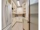 Walk-in pantry featuring white cabinets and stone countertops for optimal storage at 3640 Crump Rd, Winter Haven, FL 33881