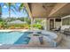 Beautiful outdoor living with pool, bar and seating area with a ceiling fan for a cool experience at 3640 Crump Rd, Winter Haven, FL 33881