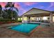 Resort-style pool and patio with an outdoor kitchen, seating, and covered area at 3640 Crump Rd, Winter Haven, FL 33881