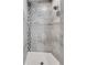 Modern shower featuring gray stone tile, decorative accent strip, and a shower head at 3640 Crump Rd, Winter Haven, FL 33881