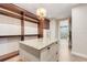 A luxury walk-in closet with custom shelving and center island with stone countertop at 3640 Crump Rd, Winter Haven, FL 33881