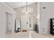 Bright entryway with high ceilings, tile flooring, a front door with sidelights, and a decorative chandelier at 3830 Spring Breeze Dr, Orlando, FL 32829