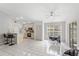 Bright kitchen and dining area with light wood cabinets, a breakfast bar, tile flooring, and sliding glass doors at 3830 Spring Breeze Dr, Orlando, FL 32829