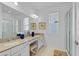A bright primary bathroom featuring double sinks, a vanity area, and a glass enclosed shower at 4569 Cabello Loop, Kissimmee, FL 34746