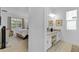 View into the bedroom and primary bathroom featuring a vanity area with stylish decorations at 4569 Cabello Loop, Kissimmee, FL 34746