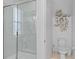 Bright bathroom featuring glass enclosed shower, toilet, and decorative shelving at 4569 Cabello Loop, Kissimmee, FL 34746