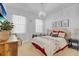 Charming bedroom with a large bed, natural light from the windows, and a decorative chandelier at 4569 Cabello Loop, Kissimmee, FL 34746