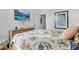 Comfortable bedroom with floral bedding, side tables, and a wall-mounted TV, perfect for relaxation at 4569 Cabello Loop, Kissimmee, FL 34746