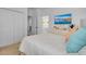 Bright bedroom with a white bed, dresser with TV, and double closet doors for ample storage at 4569 Cabello Loop, Kissimmee, FL 34746