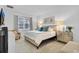 A well-lit bedroom features neutral decor, a large window, and an ensuite bathroom at 4569 Cabello Loop, Kissimmee, FL 34746
