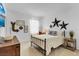Cozy bedroom featuring a metal-framed bed, decorative wall art, and a window with natural light at 4569 Cabello Loop, Kissimmee, FL 34746