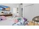 Bedroom with a floral comforter, and a large flat screen tv above a wooden dresser at 4569 Cabello Loop, Kissimmee, FL 34746