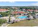 Community clubhouse and pool area with palm trees, seating, and a recreational area at 4569 Cabello Loop, Kissimmee, FL 34746
