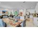 Open dining area with view of modern kitchen, elegant chandelier, and staircase at 4569 Cabello Loop, Kissimmee, FL 34746