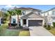 Charming two-story home with a two-car garage, well-manicured lawn, and swaying palm trees at 4569 Cabello Loop, Kissimmee, FL 34746