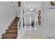 Spacious hallway featuring staircase, marble floors, recessed lighting, and stylish decor at 4569 Cabello Loop, Kissimmee, FL 34746