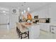 Modern kitchen featuring white cabinetry, stainless steel appliances, and a center island with seating at 4569 Cabello Loop, Kissimmee, FL 34746