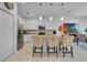 Modern kitchen with stainless steel appliances, white cabinetry, and breakfast bar seating at 4569 Cabello Loop, Kissimmee, FL 34746