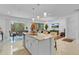 Open-concept kitchen with island seating flowing into the dining and living areas, perfect for entertaining at 4569 Cabello Loop, Kissimmee, FL 34746