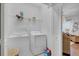 Functional laundry room with a washer, dryer, storage shelf, and ample space at 4569 Cabello Loop, Kissimmee, FL 34746
