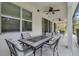 Covered patio with comfortable seating and views of the backyard and natural surroundings at 4569 Cabello Loop, Kissimmee, FL 34746