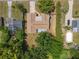 Aerial view of the home showcasing its layout, nearby pool, and mature trees providing ample shade at 4887 Seminole Ave, Winter Park, FL 32792
