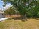Lush backyard with mature tree offering ample shade and a wooden fence at 4887 Seminole Ave, Winter Park, FL 32792