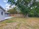 Spacious backyard featuring a lawn, mature tree, and a wood fence offering both privacy and shade at 4887 Seminole Ave, Winter Park, FL 32792