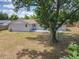 Backyard view with mature tree providing shade and a small patio area at 4887 Seminole Ave, Winter Park, FL 32792