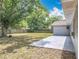 An expansive backyard featuring a concrete patio and lush greenery, offering a private outdoor retreat at 4887 Seminole Ave, Winter Park, FL 32792