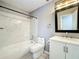 Updated bathroom features marble-look tile shower, white vanity, and modern fixtures at 4887 Seminole Ave, Winter Park, FL 32792