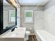 Nicely updated bathroom featuring modern vanity, and tub shower combo at 4887 Seminole Ave, Winter Park, FL 32792