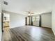 Spacious bedroom featuring wood-look floors, ceiling fan, and natural light from a window at 4887 Seminole Ave, Winter Park, FL 32792