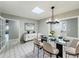 Elegant dining room with modern chandelier, skylight, and view of the front entry at 4887 Seminole Ave, Winter Park, FL 32792