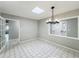 Dining room with modern chandelier and view to the front entry at 4887 Seminole Ave, Winter Park, FL 32792