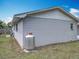 Side exterior of the house with propane tank and well-maintained yard at 4887 Seminole Ave, Winter Park, FL 32792