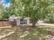 Attractive home with a fenced yard, framed by a mature shade tree at 4887 Seminole Ave, Winter Park, FL 32792