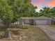 Charming single-story home with a well-manicured lawn and mature shade tree at 4887 Seminole Ave, Winter Park, FL 32792