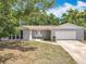 Charming single-story home with a well-manicured lawn and attached two-car garage at 4887 Seminole Ave, Winter Park, FL 32792