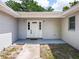 Up close front entry featuring sidelights, classic door, and a covered porch at 4887 Seminole Ave, Winter Park, FL 32792