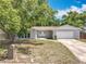 Well-maintained home featuring a classic white front door and a two-car garage at 4887 Seminole Ave, Winter Park, FL 32792