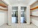Hallway with white bifold closet doors and tile flooring leading to living spaces at 4887 Seminole Ave, Winter Park, FL 32792