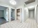 Hallway view features tiled flooring, storage closet, and entryways to other rooms at 4887 Seminole Ave, Winter Park, FL 32792
